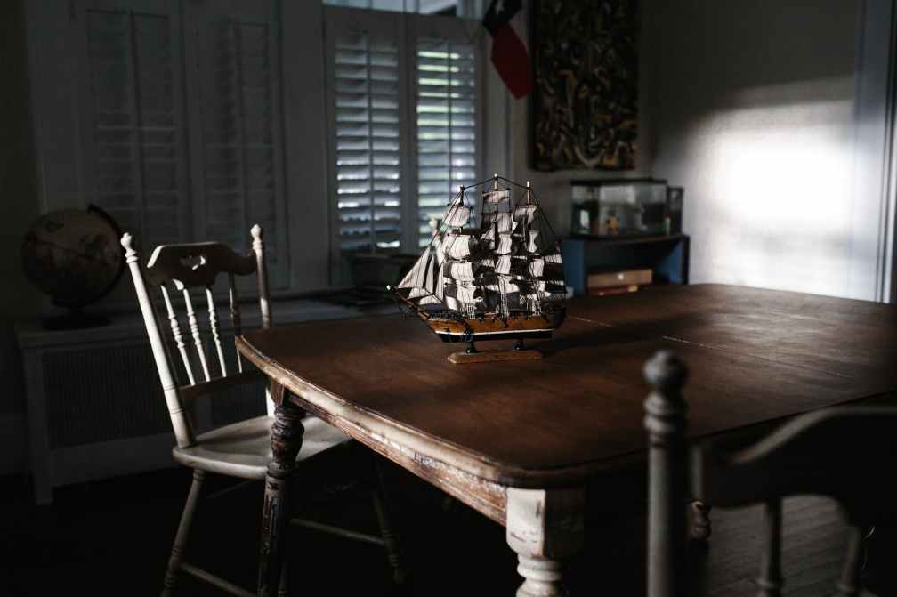 selective focus photography of miniature ship on table
