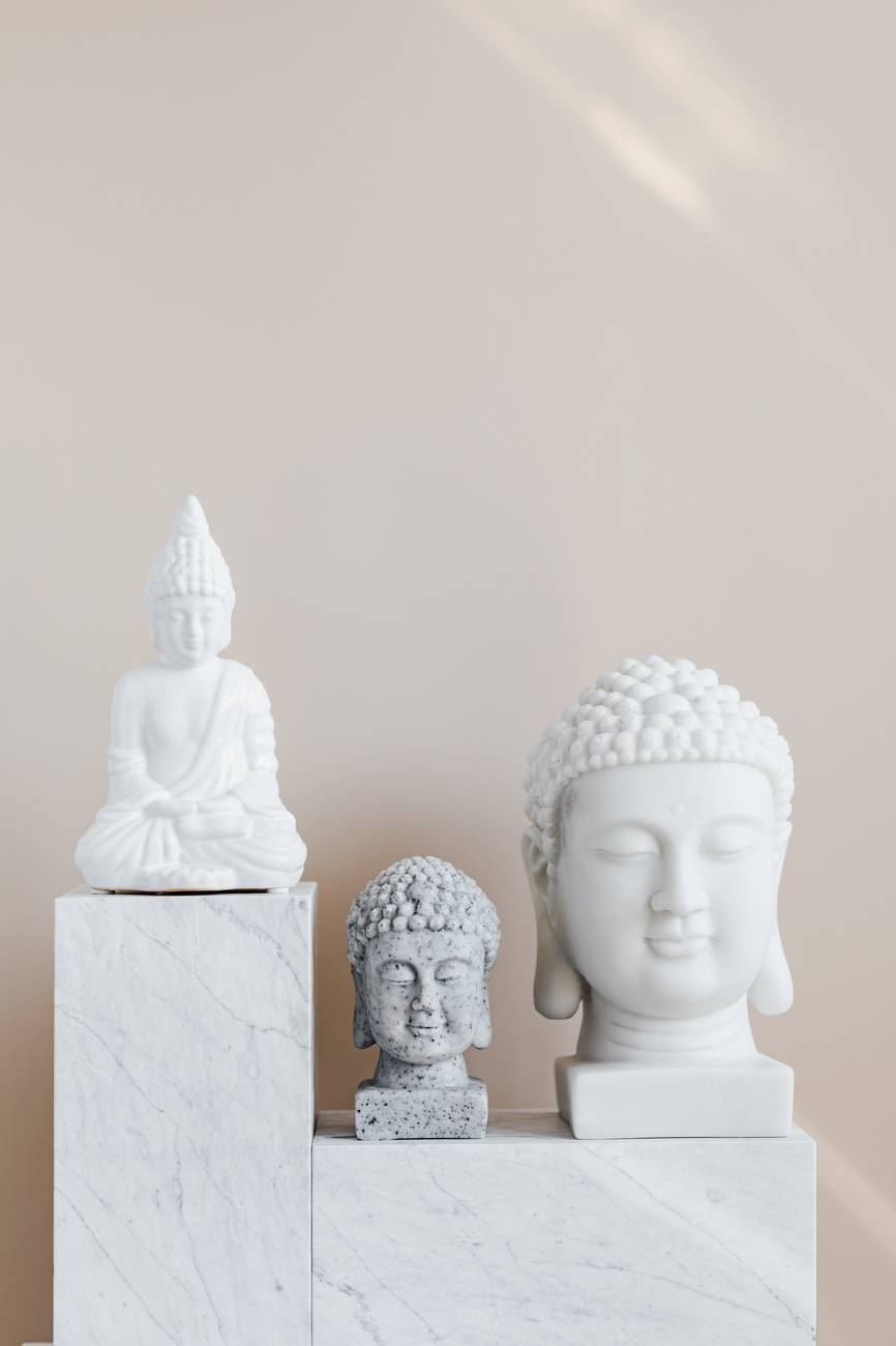 composition of buddha statues on marble stand